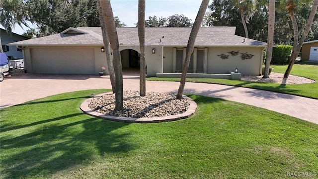 ranch-style house featuring a front yard and a garage