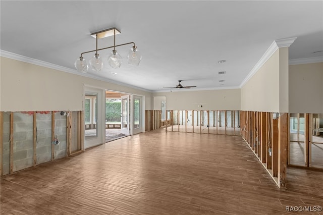 empty room featuring hardwood / wood-style floors, ceiling fan, and crown molding