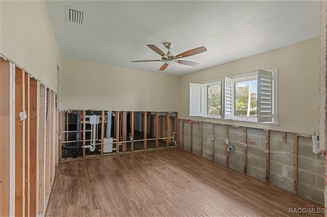 unfurnished room with ceiling fan and wood-type flooring