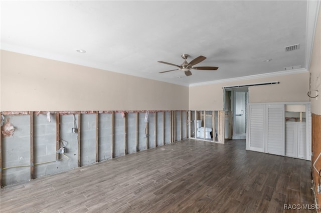 spare room featuring wood-type flooring, ceiling fan, and crown molding