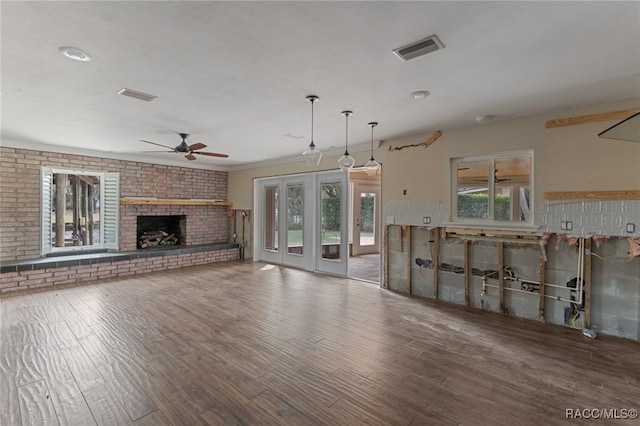 unfurnished living room featuring a fireplace, hardwood / wood-style flooring, and ceiling fan