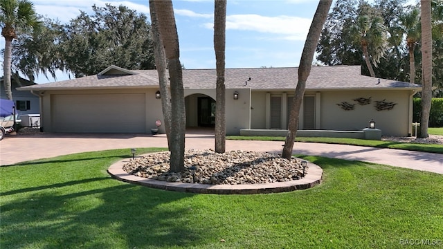 ranch-style house with a garage and a front lawn