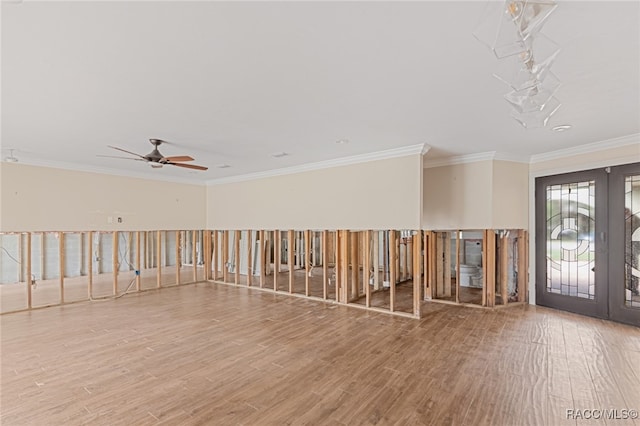 spare room with hardwood / wood-style floors, ceiling fan, ornamental molding, and french doors