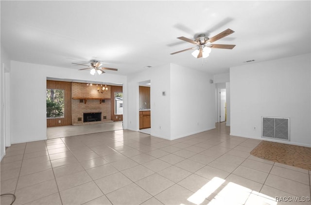 unfurnished living room with light tile patterned flooring, ceiling fan, and a fireplace