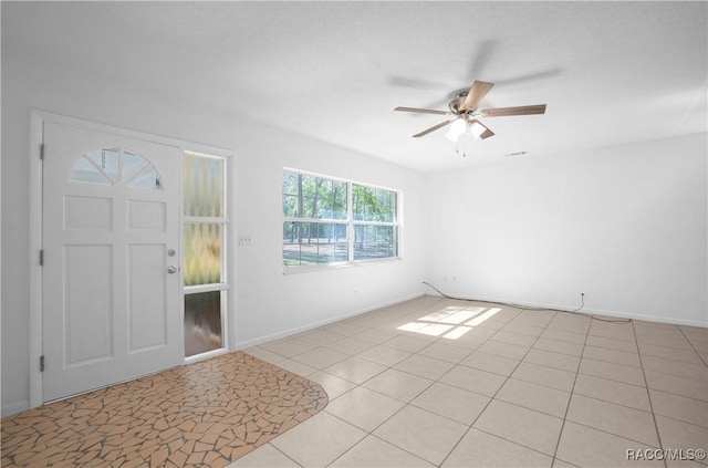 tiled entrance foyer featuring ceiling fan