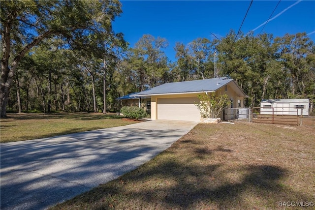 view of side of home with a garage and a yard