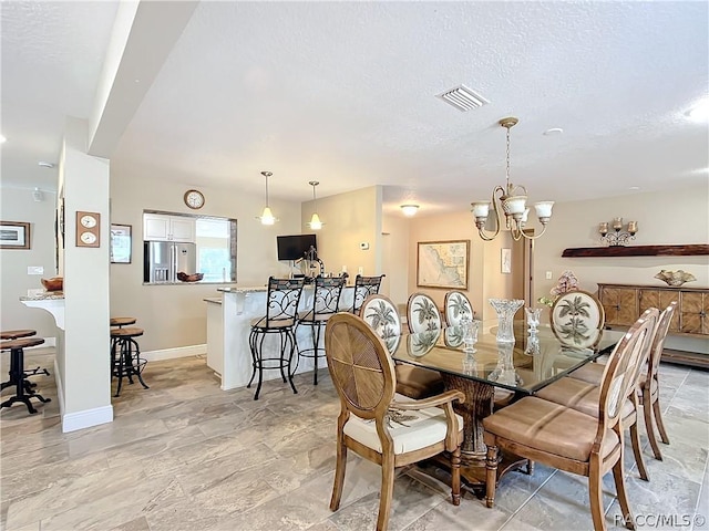 dining area featuring a notable chandelier