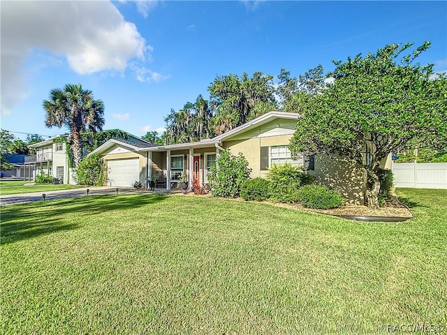 single story home with a front yard and a garage