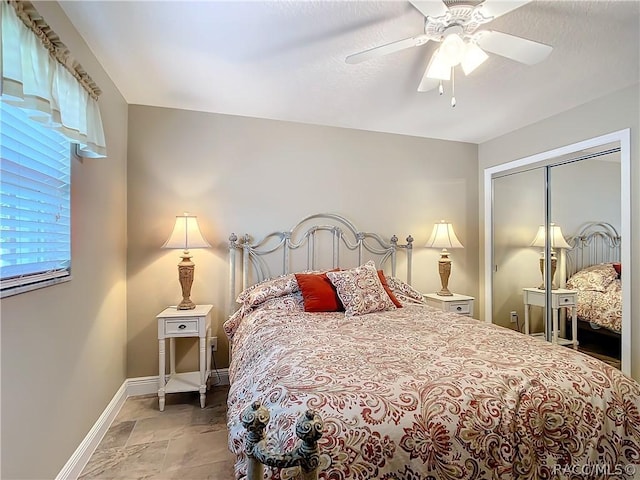 bedroom with ceiling fan and a closet