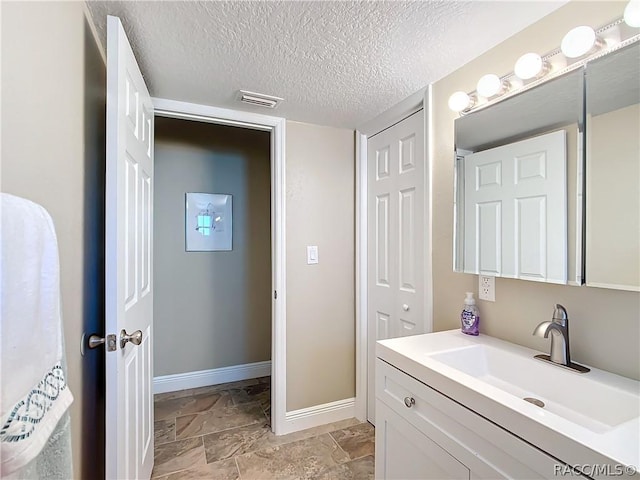 bathroom featuring vanity and a textured ceiling