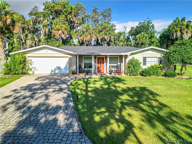 ranch-style house with a front yard and a garage