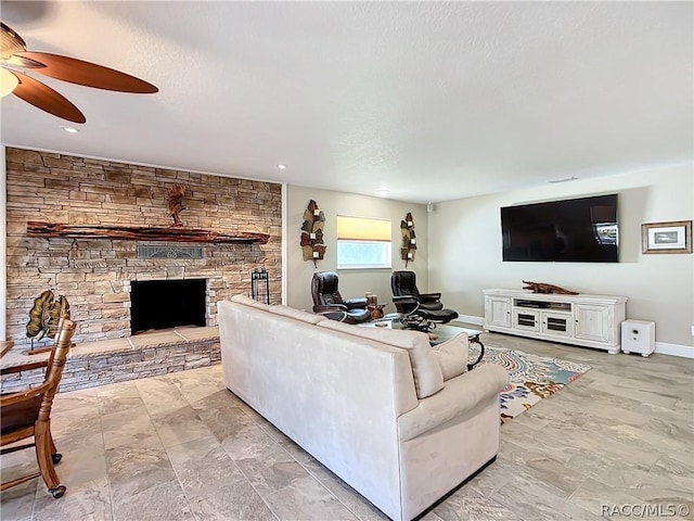 living room featuring ceiling fan and a fireplace