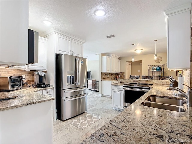 kitchen with white cabinetry, sink, stainless steel appliances, kitchen peninsula, and pendant lighting