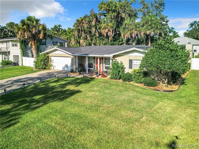 view of front facade with a garage and a front lawn