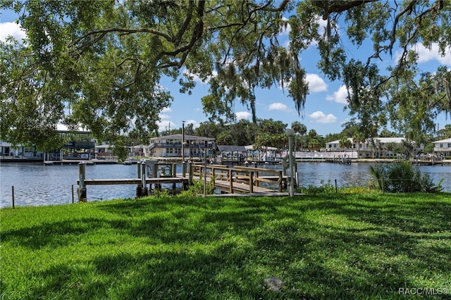 view of dock featuring a yard and a water view