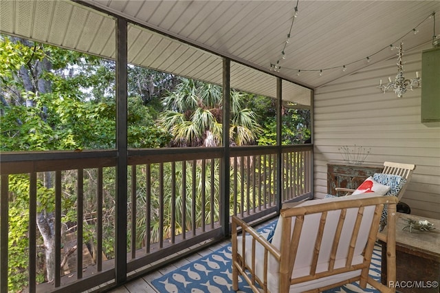 unfurnished sunroom featuring a healthy amount of sunlight and a chandelier