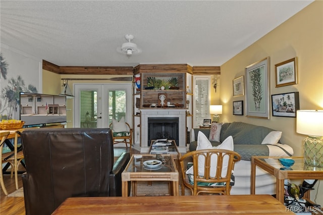 living room with hardwood / wood-style flooring, a textured ceiling, and french doors