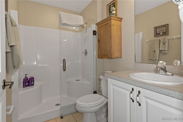 bathroom featuring tile patterned flooring, toilet, an enclosed shower, and vanity