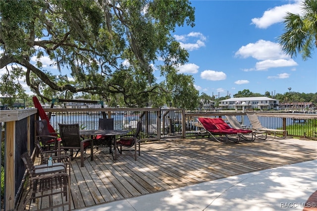 wooden deck featuring a water view