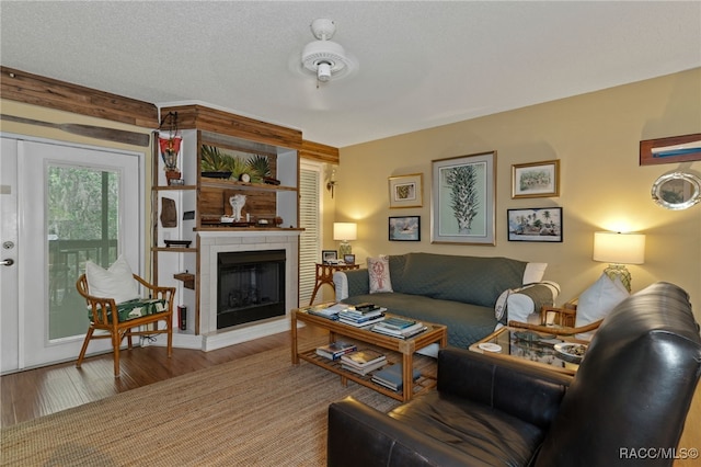 living room with a textured ceiling and hardwood / wood-style flooring