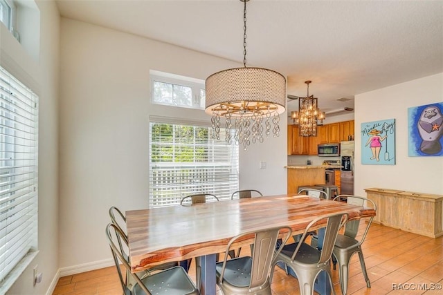 dining area featuring a chandelier and light hardwood / wood-style floors