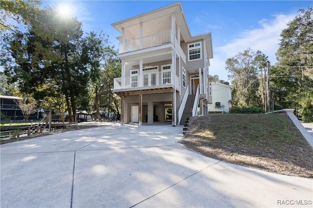 view of front of property with a balcony and a carport