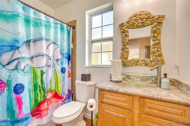 bathroom featuring a wealth of natural light, vanity, a shower with shower curtain, and toilet