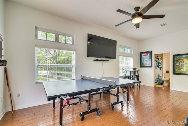 playroom with ceiling fan and light hardwood / wood-style flooring