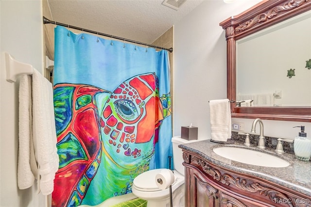 bathroom featuring vanity, a textured ceiling, and toilet