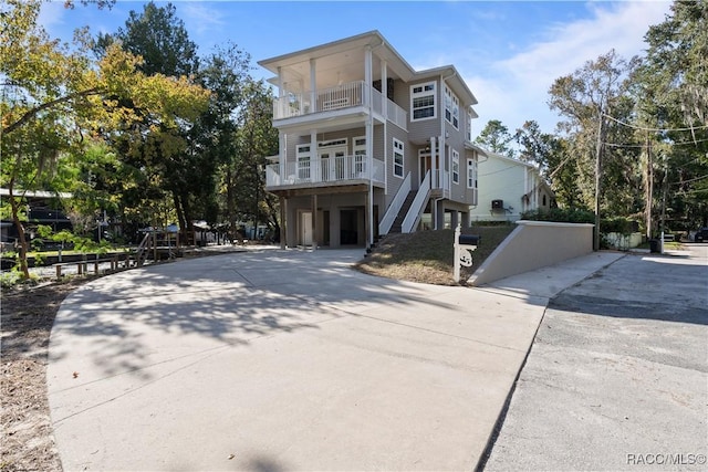 view of front of home featuring a balcony and a garage