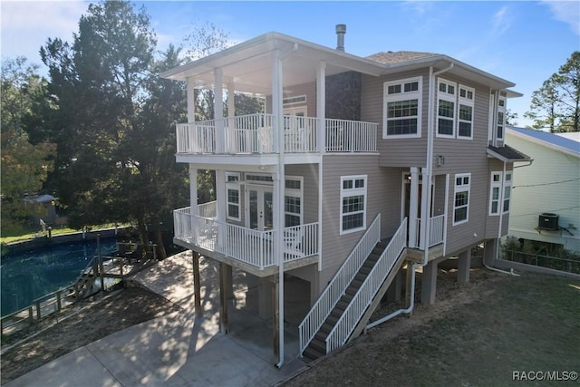 back of property featuring french doors and cooling unit