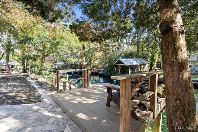 deck featuring a boat dock and a water view