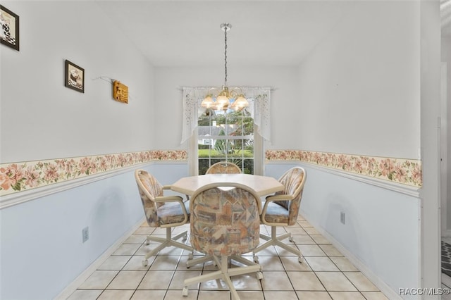 dining room with light tile patterned floors and an inviting chandelier