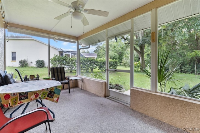 sunroom / solarium with plenty of natural light and ceiling fan