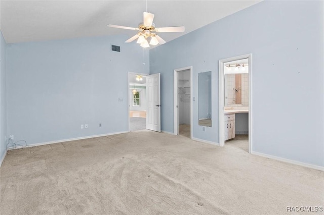 25 Redbay Ct W, Homosassa, FL 34446 - unfurnished bedroom featuring carpet, a spacious closet, connected bathroom, baseboards, and high vaulted ceiling
