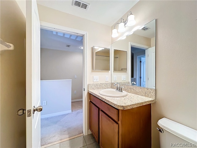 bathroom with tile patterned floors, vanity, and toilet