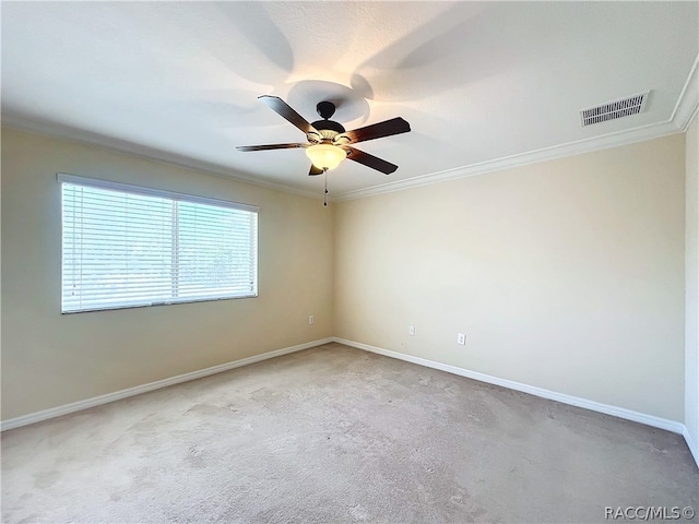 carpeted empty room with crown molding and ceiling fan