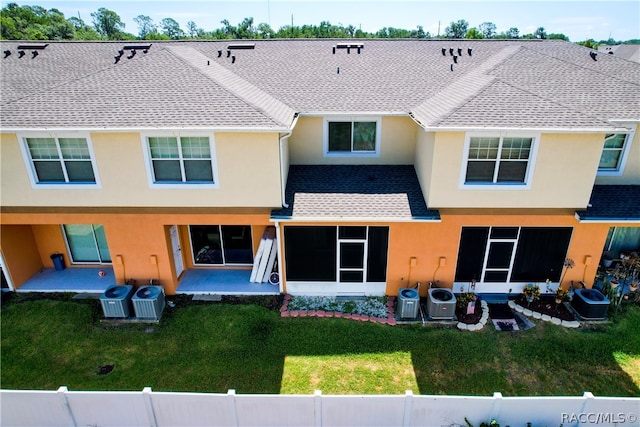 rear view of house featuring a yard, cooling unit, and a patio