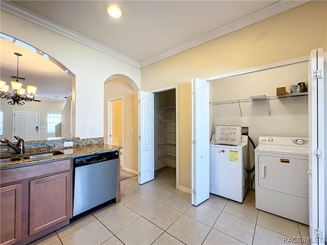 kitchen with pendant lighting, dishwasher, crown molding, separate washer and dryer, and a notable chandelier