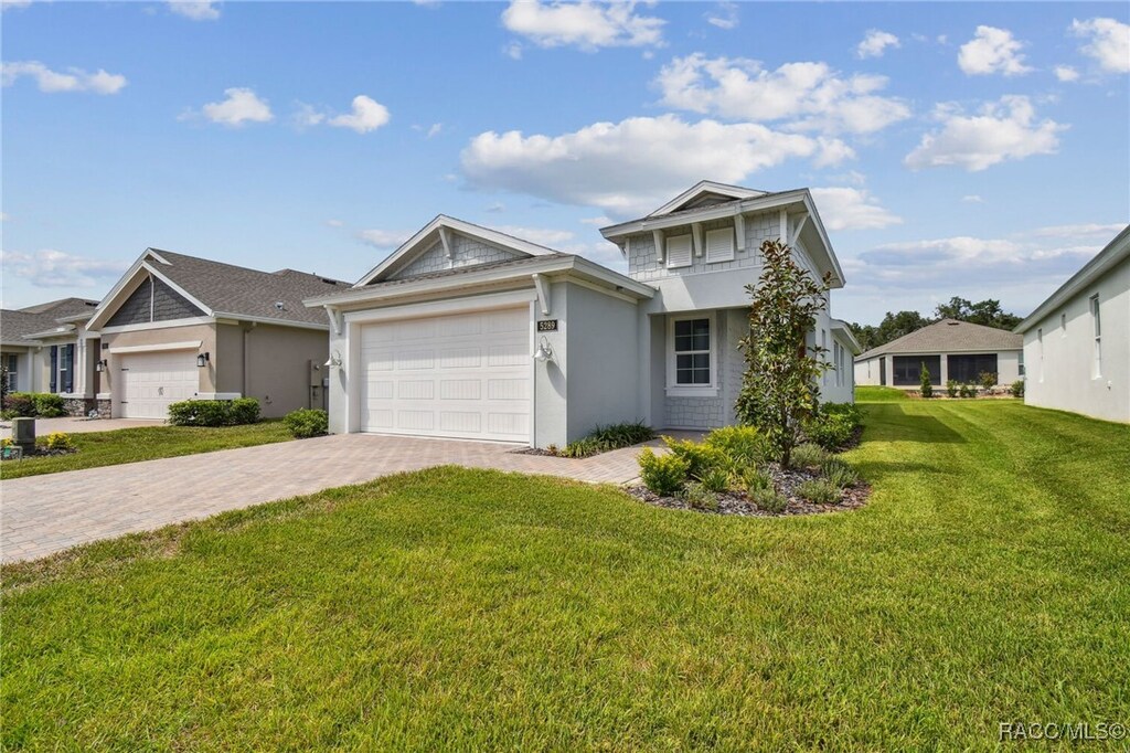 view of front facade with a front lawn and a garage