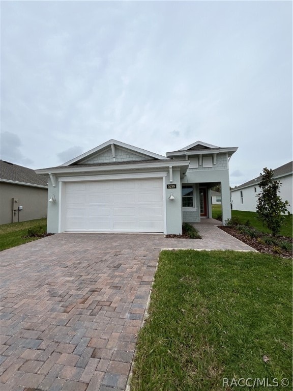 view of front facade with a front lawn and a garage