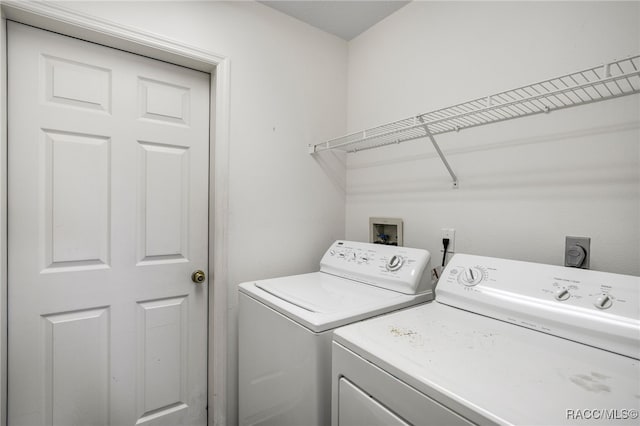 clothes washing area with laundry area and washer and clothes dryer