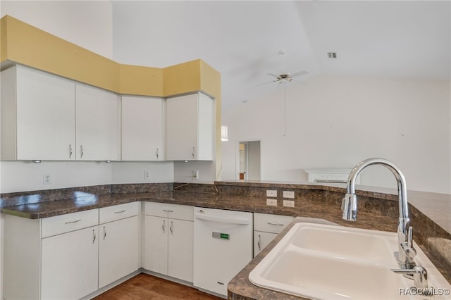 kitchen with white cabinets, a ceiling fan, lofted ceiling, white dishwasher, and a sink