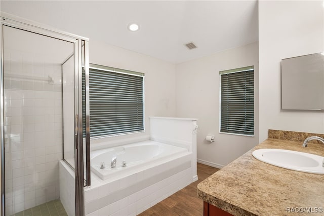 full bath with wood finished floors, visible vents, vanity, a shower stall, and a bath