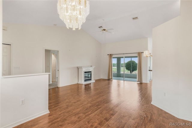 unfurnished living room featuring visible vents, a glass covered fireplace, wood finished floors, high vaulted ceiling, and ceiling fan with notable chandelier