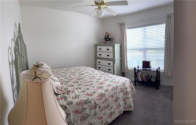 carpeted bedroom featuring ceiling fan and multiple windows