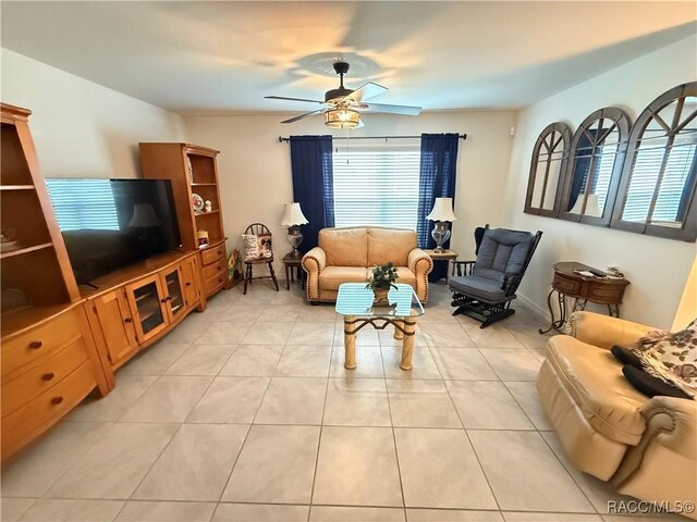 living room with a ceiling fan and light tile patterned floors