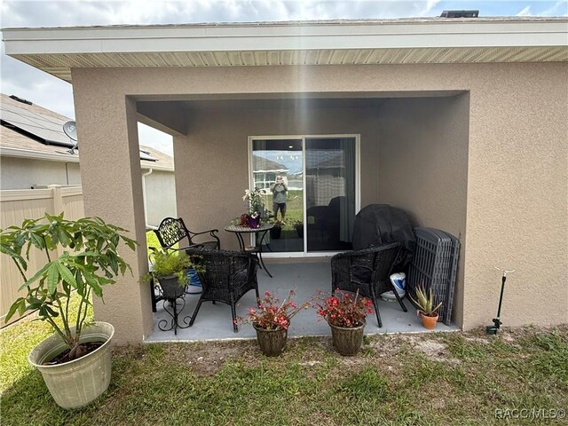 view of patio / terrace featuring fence
