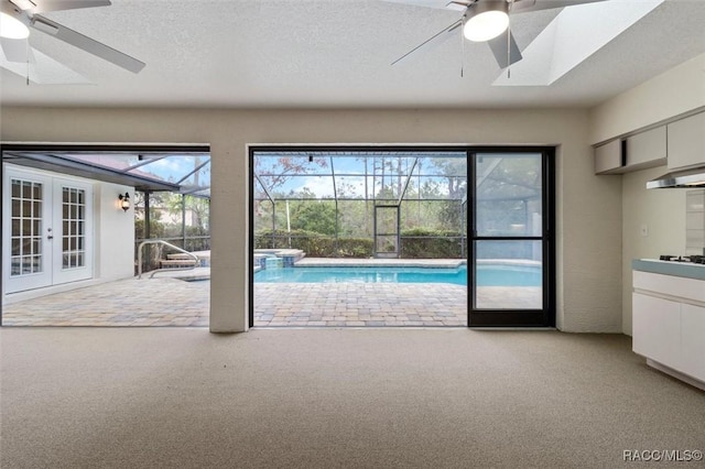 interior space with french doors and ceiling fan