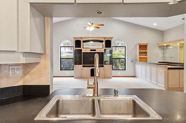 kitchen with light carpet, ceiling fan, lofted ceiling, and sink